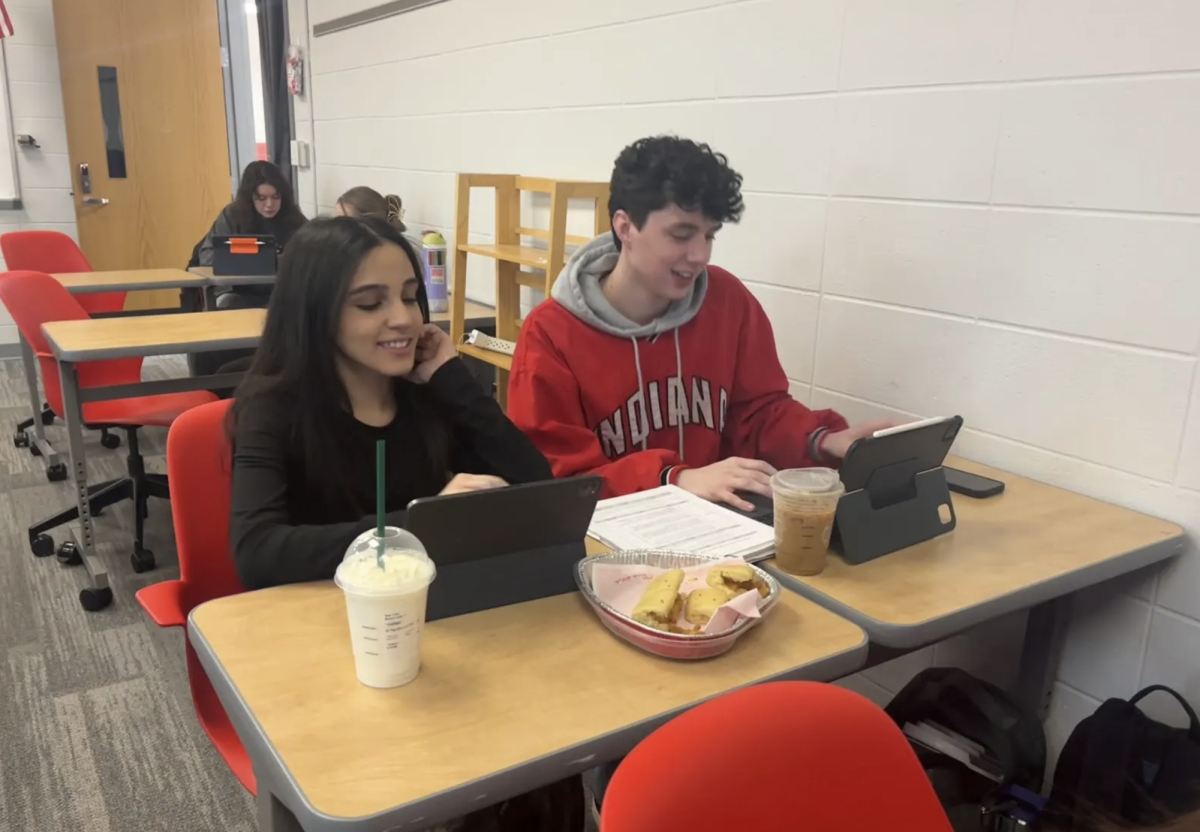 Working on their AP Lang presentation, Alex Frank ‘26 and Nia Borhan ‘26 eat Chick Fil A. Each year Chick Fil A has heart shaped trays that they serve their entrees in for Valentine’s Day. “My dad gets me the Chick Fil A each year. I think the tray is very cute and niche ,” said Frank. “This Valentine’s Day I am most excited about the new music released by Sabrina Carpenter and Drake.”